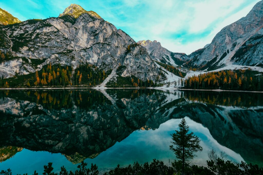 A breathtaking view of Lake Braies with mountain reflection in the Italian Alps. Ideal for nature lovers.